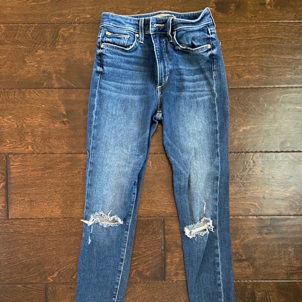 High rise skinny jeans with rips; size 25.